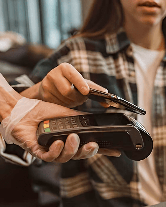A customer paying by card at a counter